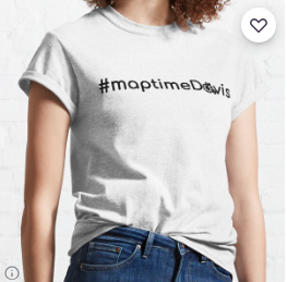 Woman wearing a white shirt with a black map time Davis logo